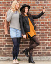 Two women leaning against a wall. They are wearing compression stockings with batik pattern