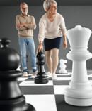 1. Lifestyle Image Juzo Dynamic Man in Juzo Dynamic stockings kneeling on a large chessboard