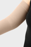 Vrouw draagt een Juzo compressiearmkous met de functionele elleboogzone