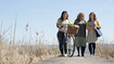 Three women on the jetty. They are wearing compression stockings.