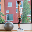 A woman standing on an aerobics step with both legs